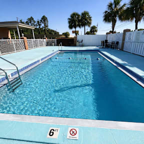 A swimming pool with a 6ft depth sign and no diving sign.