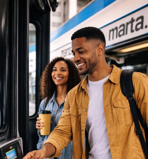 A man is paying for his bus fare with a contactless card.
