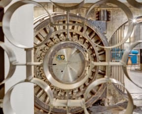 a view of a clock from the inside of a building