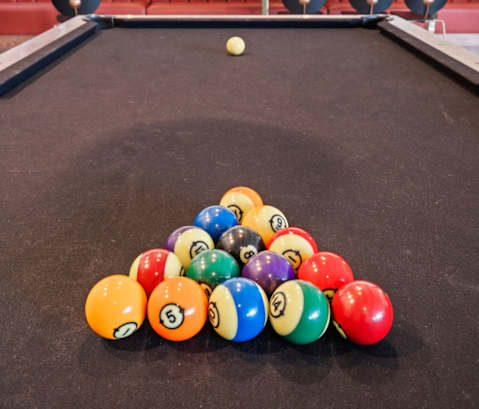 a pool table with a pile of billiard balls on it