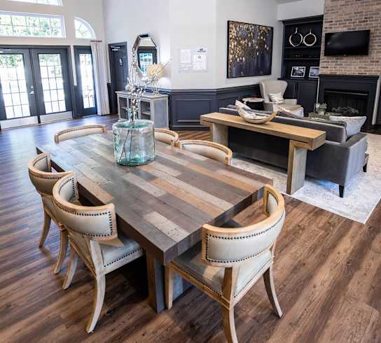 A modern dining room with a wooden table and chairs.