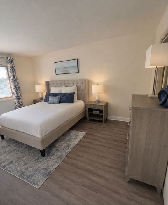 a bedroom with a bed and paintings on the wall