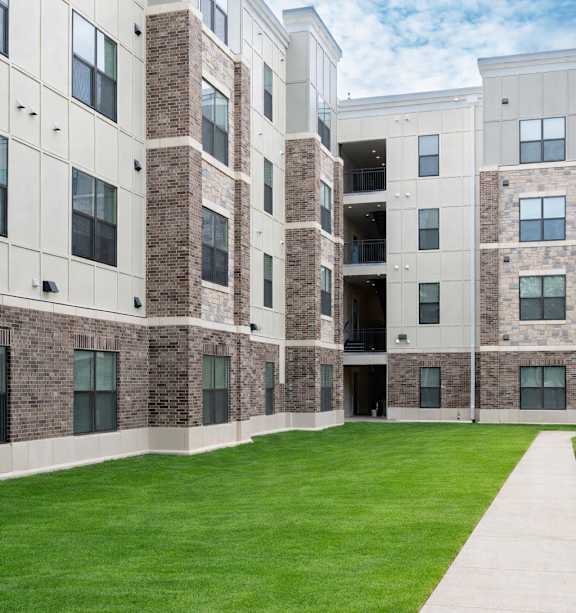 Apartment building with a car parked in front.