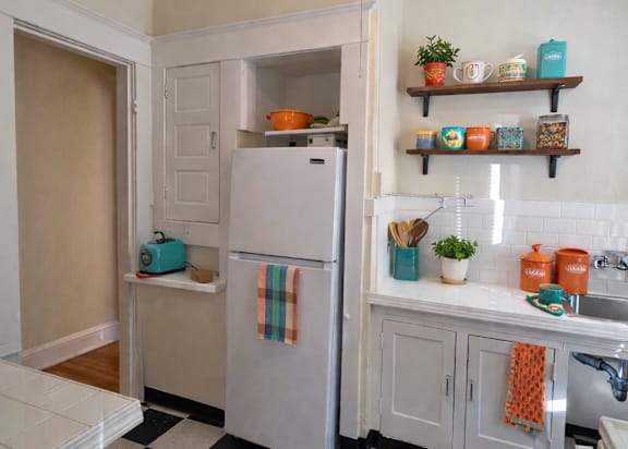 A kitchen with a black and white checkered floor. at Casa Del Rey Apartments, Oregon, 97209