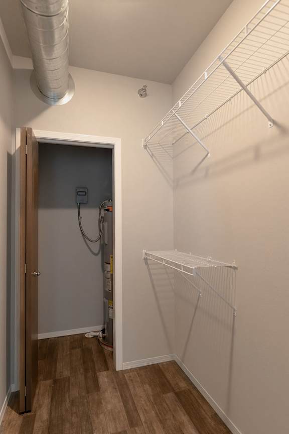 A walk-in closet with a door and shelves.