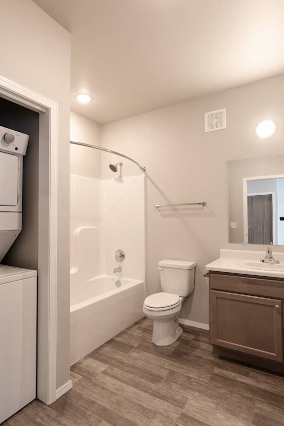 A white toilet is next to a white bathtub in a bathroom.