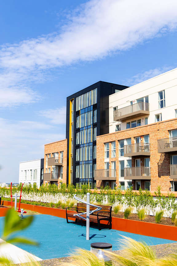 a rendering of an apartment building with a swimming pool