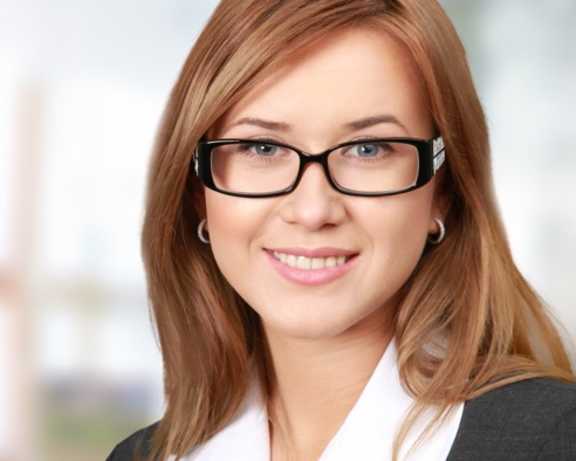 a woman wearing glasses and a white shirt