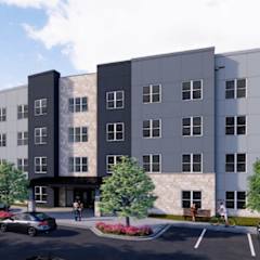 A modern apartment complex with a parking lot in front.