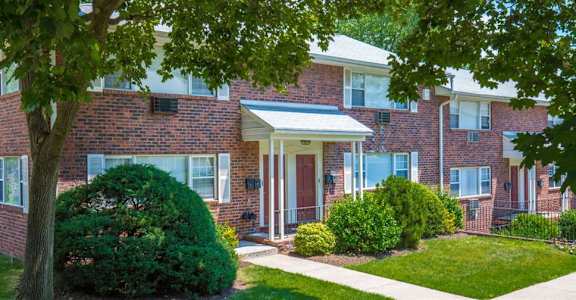 a brick house with a tree in front of it at Willow Gardens Apartments, Teaneck, New Jersey