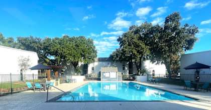 a swimming pool in the backyard of a house at Whispering Oaks in  Conroe, TX