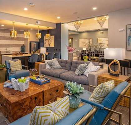A living room filled with furniture and a large window at 2000 West Creek Apartments in VA 23238