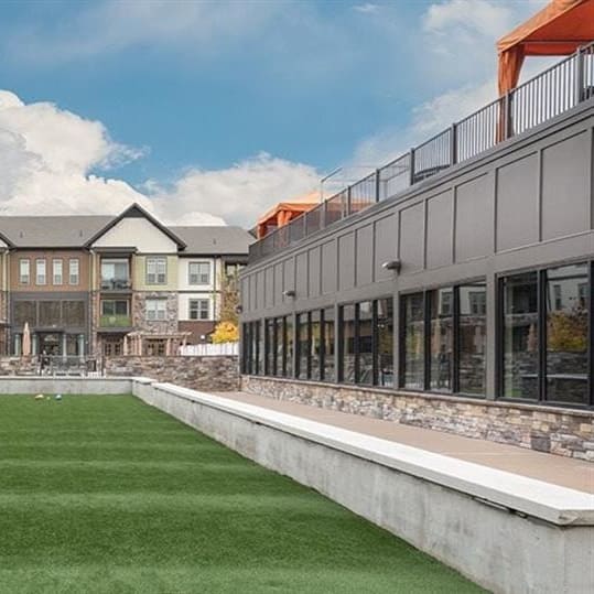 A grassy area with buildings in the background at 2000 West Creek Apartments in Richmond, 23238