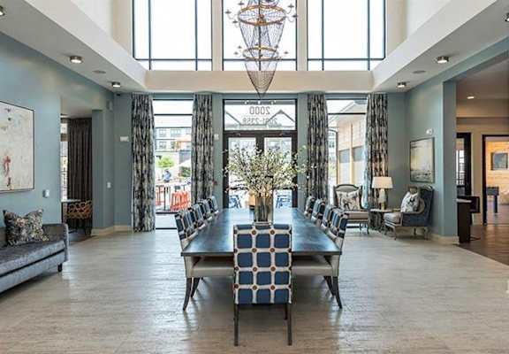 A large room with a long wooden table and chairs at 2000 West Creek Apartments in Richmond, VA 23238