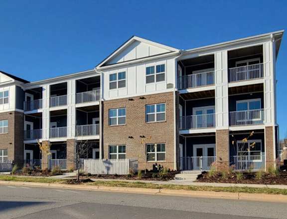 A large apartment complex with multiple balconies and doors.