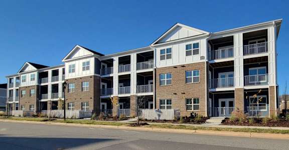 A large apartment complex with multiple balconies and doors.