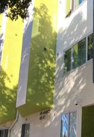people sitting on benches in front of a tall building