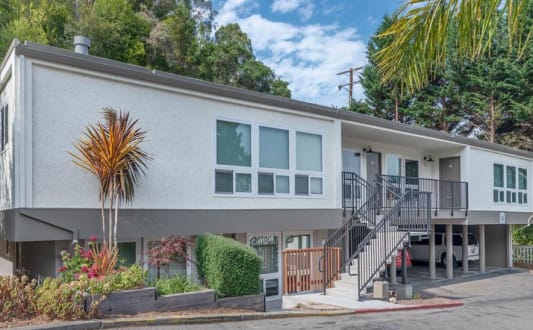 the front of a house with stairs and a driveway at Trailhead Apartments at Tam Junction, California
