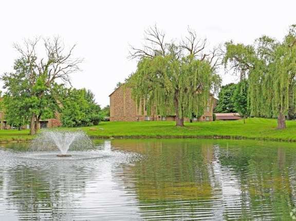 a fountain in the middle of a pond