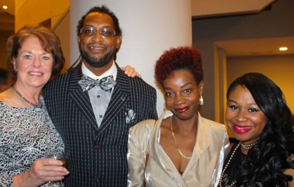 a group of people posing for a picture at a party