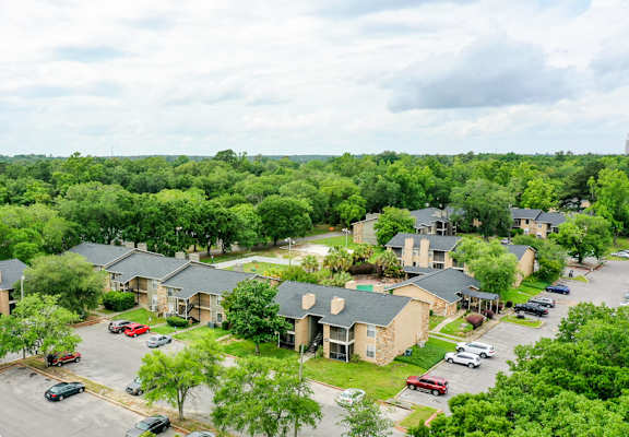 A bird's eye view of a residential area with houses and cars.
