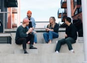 Thumbnail 10 of 10 - Friends Sitting on Steps Together Talking