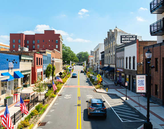 A street view of a city with cars and buildings.