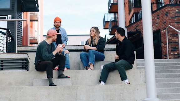 Friends Sitting on Steps Together Talking
