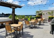 Thumbnail 14 of 22 - A patio with a table and chairs under a pergola.