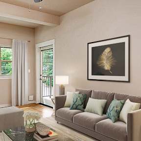 A living room with a grey couch, a coffee table, and a painting on the wall.