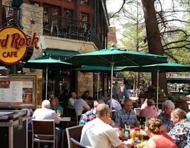 Hard Rock Cafe is a popular dining spot with people enjoying their meals outside.