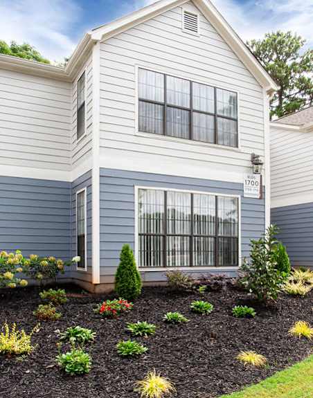 the front of a house with a landscaped yard