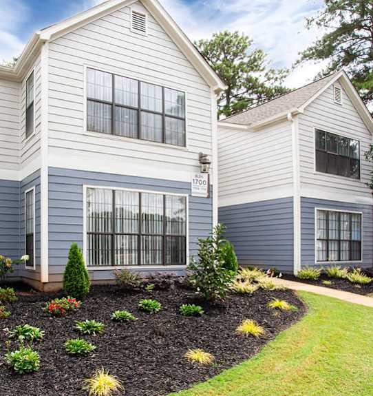 the front of a house with a landscaped yard