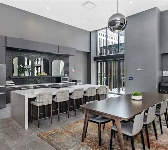 A modern kitchen with a dining table set for six.