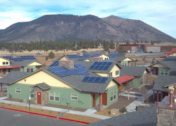 A small town with houses and solar panels on the roofs.