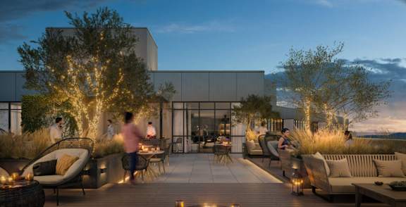 a rendering of the rooftop terrace at night with people sitting on it