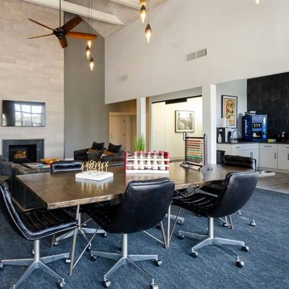 clubhouse with a table and chairs and a fireplace