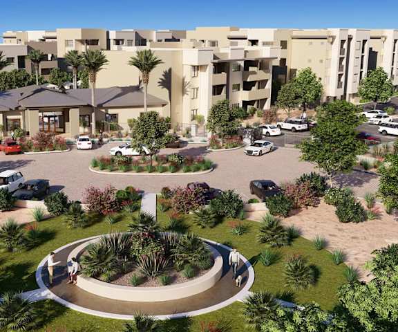 The arial view of the front at Reflect at Dobson Ranch Apartment Homes showing a parking lot, a circular garden, the apartment buildings, and the front office. 