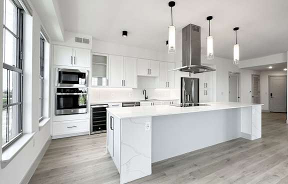 Expansive kitchens and islands with stainless steel appliances