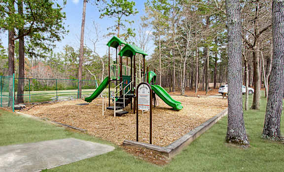a playground with a slide in a park at Lory of Harbison, Columbia, SC