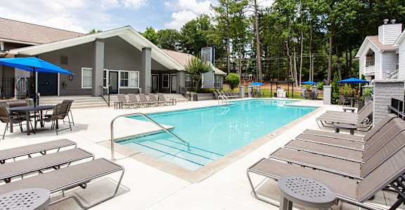 our apartments have a large pool and lounge chairs at The Hub at 934 Apartments, Georgia, 30349