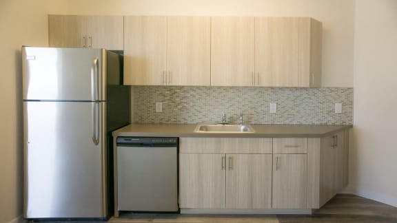 Kitchen with stainless steel refrigerator and dishwasher