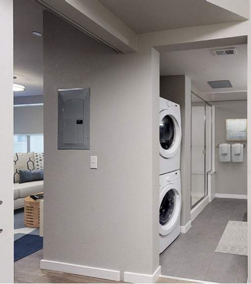 A laundry room with a washer and dryer.at The Logan Apartments, Denver Colorado