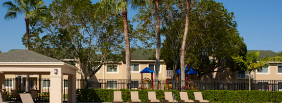 A pool surrounded by white chairs and a white fence. at The Regency, Virginia, 20109