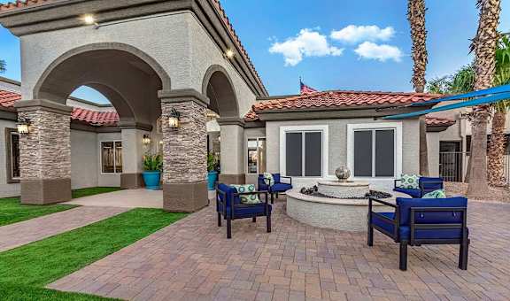 Outdoor patio with blue chairs at Springs at Continental Ranch, Tucson, Arizona