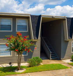 a gray house with a blue sky in the background at Auburn Glen Apartments, Florida, 32256