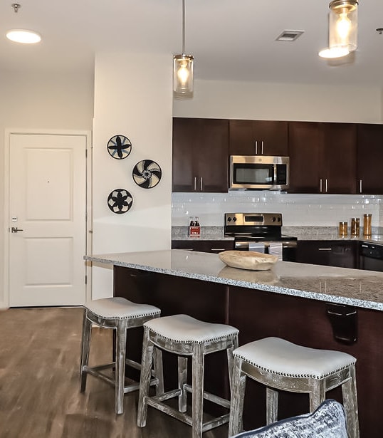 a kitchen with stainless steel appliances and a counter top at The Station at River Crossing, Georgia