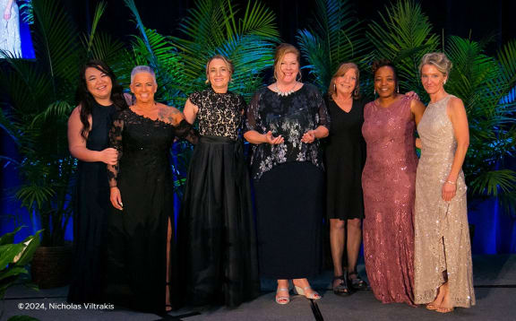 a group of women posing for a photo at a party