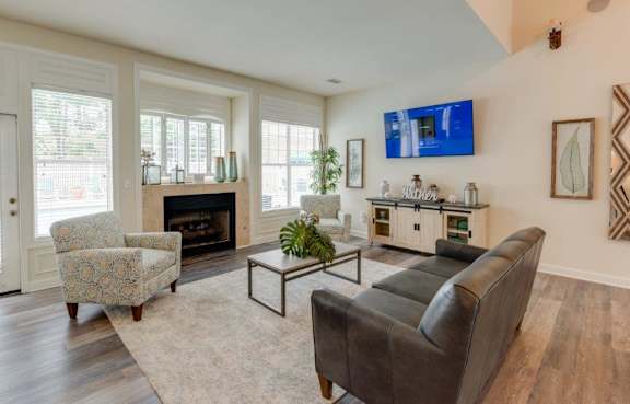 A living room with a grey chair and a wooden table.