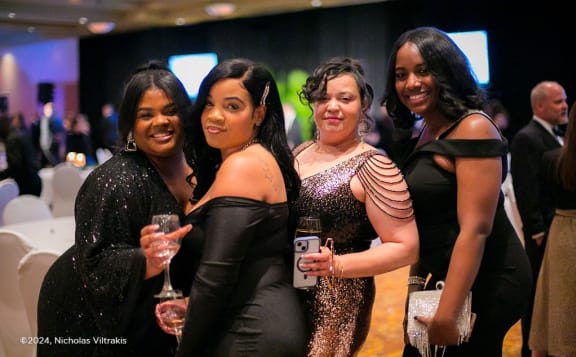 a group of women posing for a photo at a party